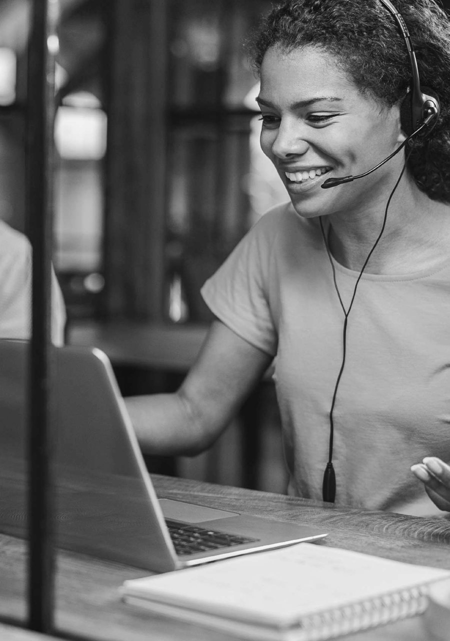 Consultant on a headset call at a laptop
